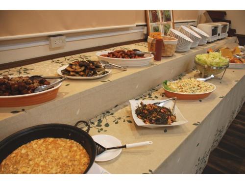 a buffet line with many different types of food at Sun Hotel Tosu Saga - Vacation STAY 49470v in Tosu