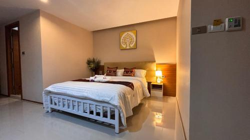 a bedroom with a bed and a clock on the wall at Sam Homestay in Bangkok