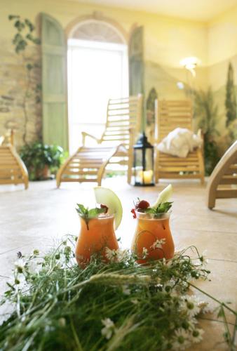 a patio with two orange vases on the floor at Landhotel Rittersgrün in Breitenbrunn