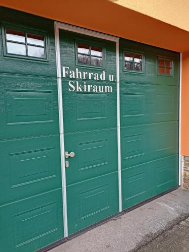 a pair of green garage doors with the words familiar istg istg at Landhotel Rittersgrün in Breitenbrunn