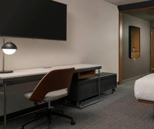 a room with a desk with a monitor and a chair at Courtyard by Marriott San Diego Miramar in San Diego