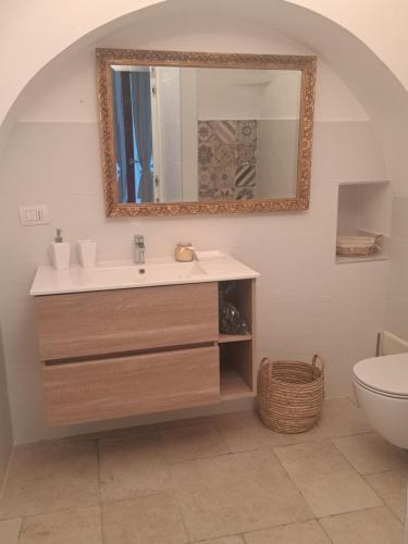 a bathroom with a sink and a mirror at Viale del Sole - il Trullo in Locorotondo