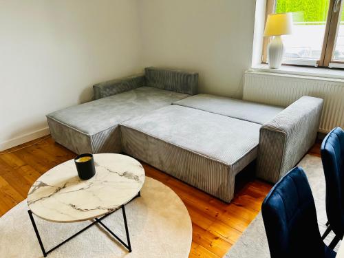 a bedroom with a bed and a table and chairs at Stilvolle Studiowohnung mit Sonnenterasse in Rheda-Wiedenbrück