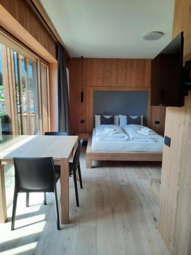 Postel nebo postele na pokoji v ubytování Ama Dolomiti - Residence