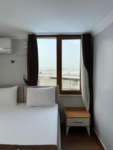 A bed or beds in a room at Tavra hotel