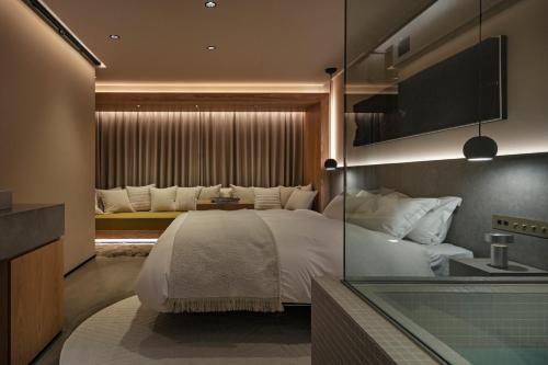 a bedroom with a large white bed and a window at HotelCO Kuramae ホテル コ 蔵前 in Tokyo
