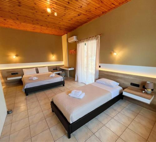 a bedroom with two beds in a room at Island Apartments in Mesolongion