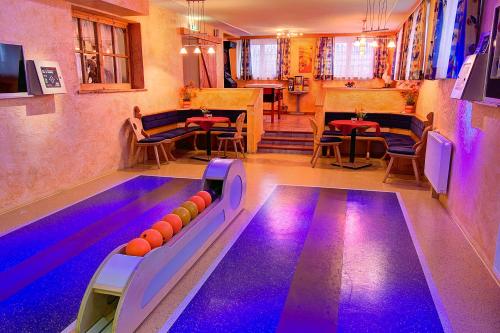 a bowling alley with a pool and a table at Der Brückenhof Ramsau in Ramsau am Dachstein