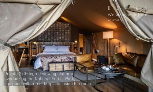 a bedroom with a bed and a couch and a table at BZIKA Wonderland Retreat--Zhangjiajie National Forest Park Store in Zhangjiajie