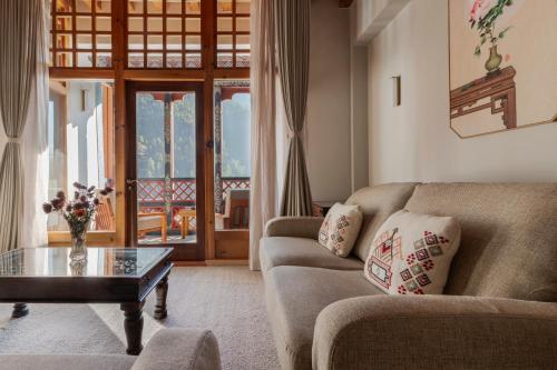 a living room with a couch and a table at Zhiwaling Heritage in Paro