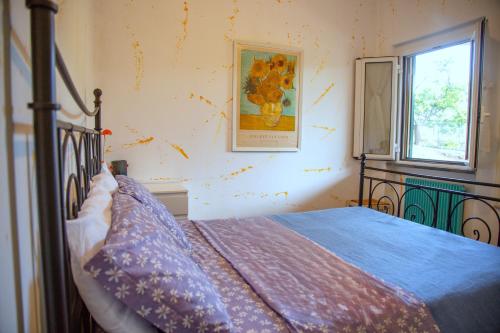 a bedroom with a bed and a window at Sea Point in Celle Ligure