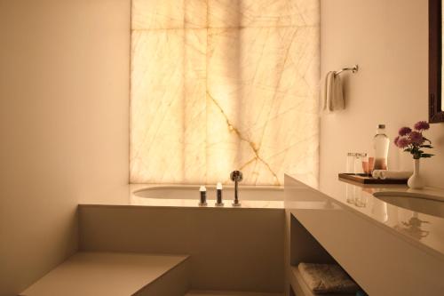 a bathroom with a tub and a sink at Zhiwaling Heritage in Paro