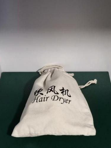 a white bag with the words ashir hair diver on it at Hennessy Hotel in Hong Kong