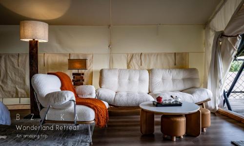 a living room with two chairs and a table at BZIKA Wonderland Retreat--Zhangjiajie National Forest Park Store in Zhangjiajie