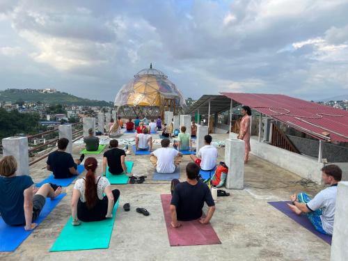 a group of people doing yoga on the roof of a building at Hamro Family Ghar Apartment or Room near Kathmandu in Kathmandu