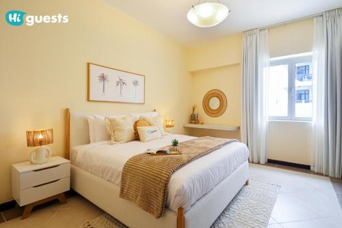 a bedroom with a large bed and a window at HiGuests - Elegant Family Retreat in Dubai's Deira 3BR Oasis in Dubai