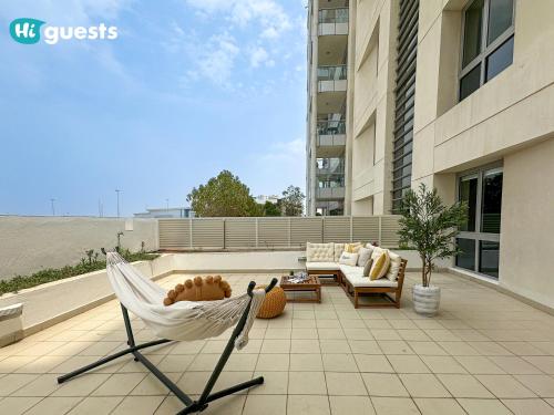 a hammock on top of a patio in a building at HiGuests - Elegant Family Retreat in Dubai's Deira 3BR Oasis in Dubai