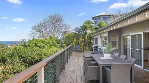 a deck with a table and chairs on a house at Copa Sunrise Ocean Views, Close To Beach in Copacabana