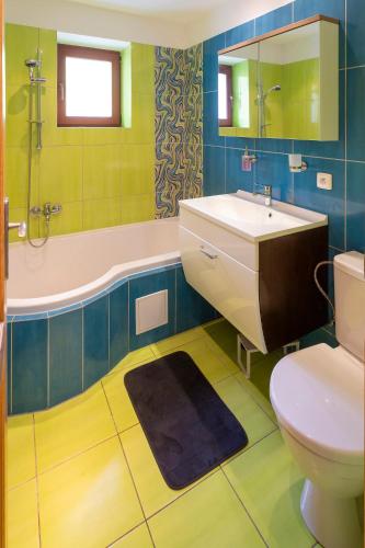 a bathroom with a sink and a tub and a toilet at Chata Juta Horní Bečva in Horní Bečva