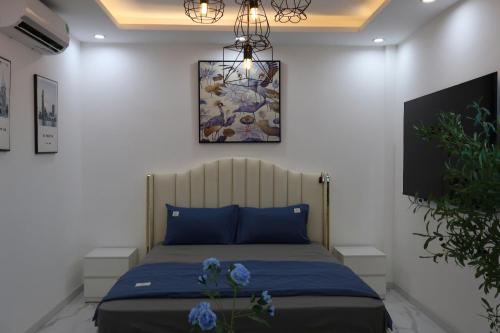 a bedroom with a bed and a painting on the wall at The Grand Diamond C Hotel in Trung Ðồng