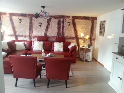 a living room with a red couch and a table at Ferienhaus Sankt Andreasberg in Sankt Andreasberg