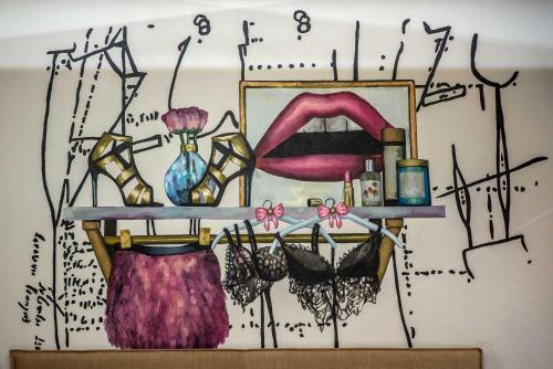 a painting of a wall with a shelf with cosmetics at Artagonist Art Hotel in Vilnius