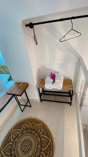 a room with a table with towels and a rug at Babatseratsi skyrian studio 1 in Skiros