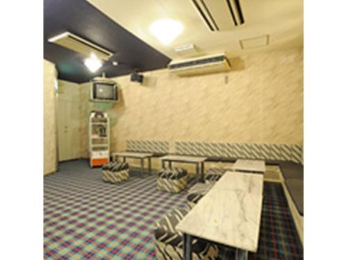 a room with tables and chairs and a wall at Mount View Hotel - Vacation STAY 40142v in Kamikawa