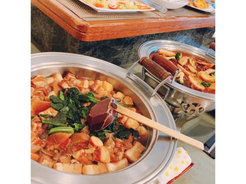 a pot full of food with a wooden spoon in it at Mount View Hotel - Vacation STAY 40138v in Kamikawa