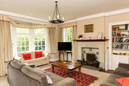 a living room with two couches and a fireplace at Newholme House in Stirling