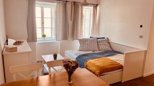a small room with a bed and a table at Četnická Stanice Mšeno in Mšeno