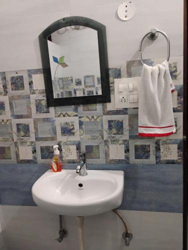 a bathroom with a sink and a mirror at Swaran bnb near Mcleodganj in Dharamshala