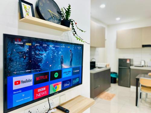 a flat screen tv on a wall in a living room at The Sun 1 or 3BR Bayan Lepas 4 to 10 pax WL in Bayan Lepas