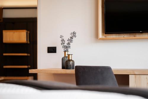 Ένα ή περισσότερα κρεβάτια σε δωμάτιο στο Hotel Alpenrose Dolomites