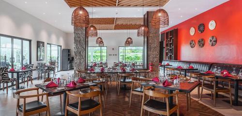 a restaurant with tables and chairs and red walls at Upscale 2bd & 2ba Apt in Swara Ranch in Maiyan in Nanyuki