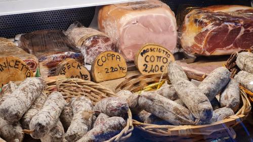 a display of different types of meats and cheese at La Cà Granda, quiet house with mountain views in Gandellino