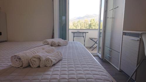 Posteľ alebo postele v izbe v ubytovaní Hotel Ogliastra