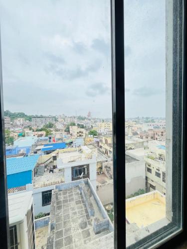 a view of a city from a window at METRO HOTEL Nathdwara , 500mtr 10min walking from shreenathji temple 966o9o1oo6 in Nāthdwāra