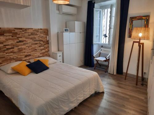 une chambre avec un lit et un mur de briques dans l'établissement Appartement spacieux T2 avec vue mer d'exception au pied des plages, à Collioure