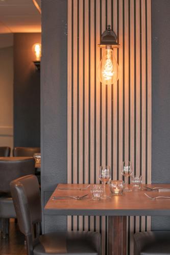 a table in a restaurant with wine glasses on it at City hotel Terneuzen in Terneuzen