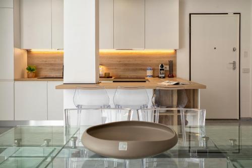 a kitchen with a counter with two chairs and a table at LUXURY HOUSE Olbia center with private garden in Olbia