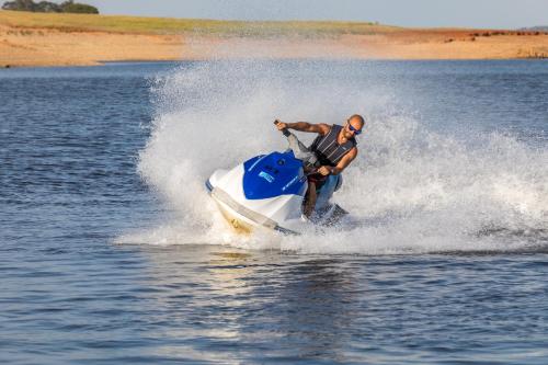 a man on a jet ski in the water at AP Lago Montargil - Conference & SPA in Montargil