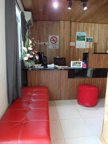 a red bench sitting in front of a counter at 69 Hotel in Melaka