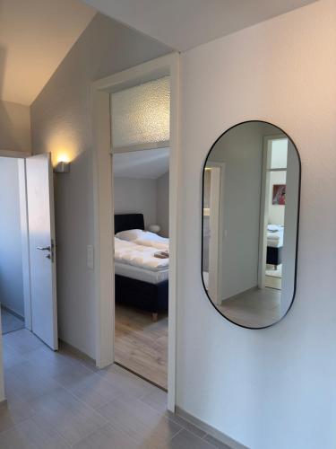 a mirror on a wall in a room with a bed at Ruheoase 100 qm & hochwertige Vollausstattung in Jülich