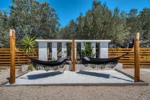 two hammocks in front of a fence at Green Poetree Houses in Galatas