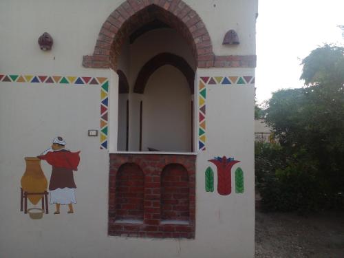 a painting on the side of a building at Tasneem Palace in Luxor