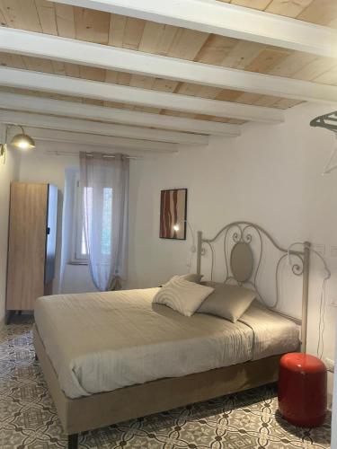 a bedroom with a large bed with a wooden ceiling at Torre Anna in Riomaggiore