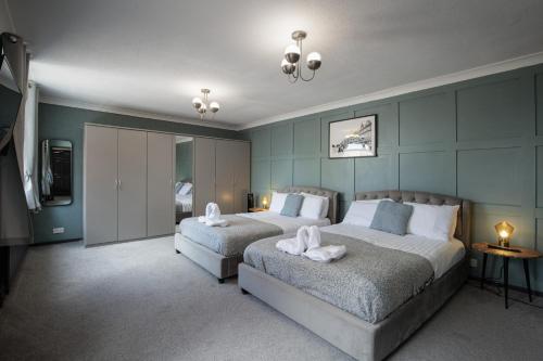a bedroom with two beds with white towels on them at Bentinck Residence by Sasco Apartments in Lytham St Annes