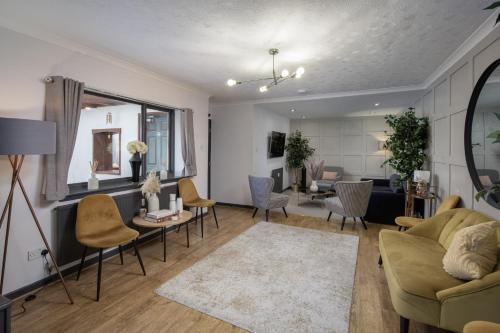 a living room with a couch and chairs at Bentinck Residence by Sasco Apartments in Lytham St Annes