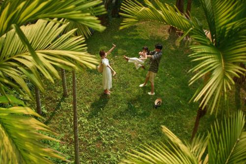 a group of people standing in the grass at InterContinental Xishuangbanna Resort by IHG in Jinghong